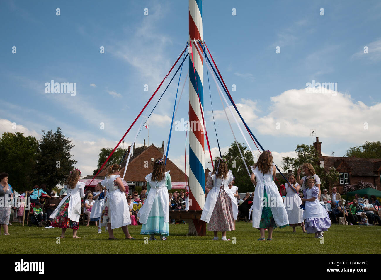 Children dance round the ancient maypole on the village green of Wellow Nottinghamshire Stock Photo