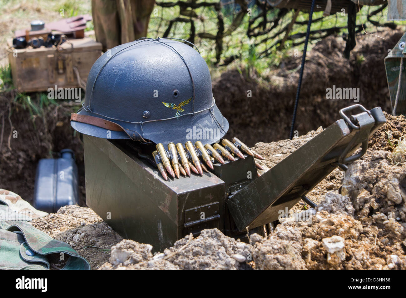 Overlord, D-Day re-enactment at Denmead 2013. Still life of German helmet, machine gun ammunition box and bullets in a dug out. Stock Photo