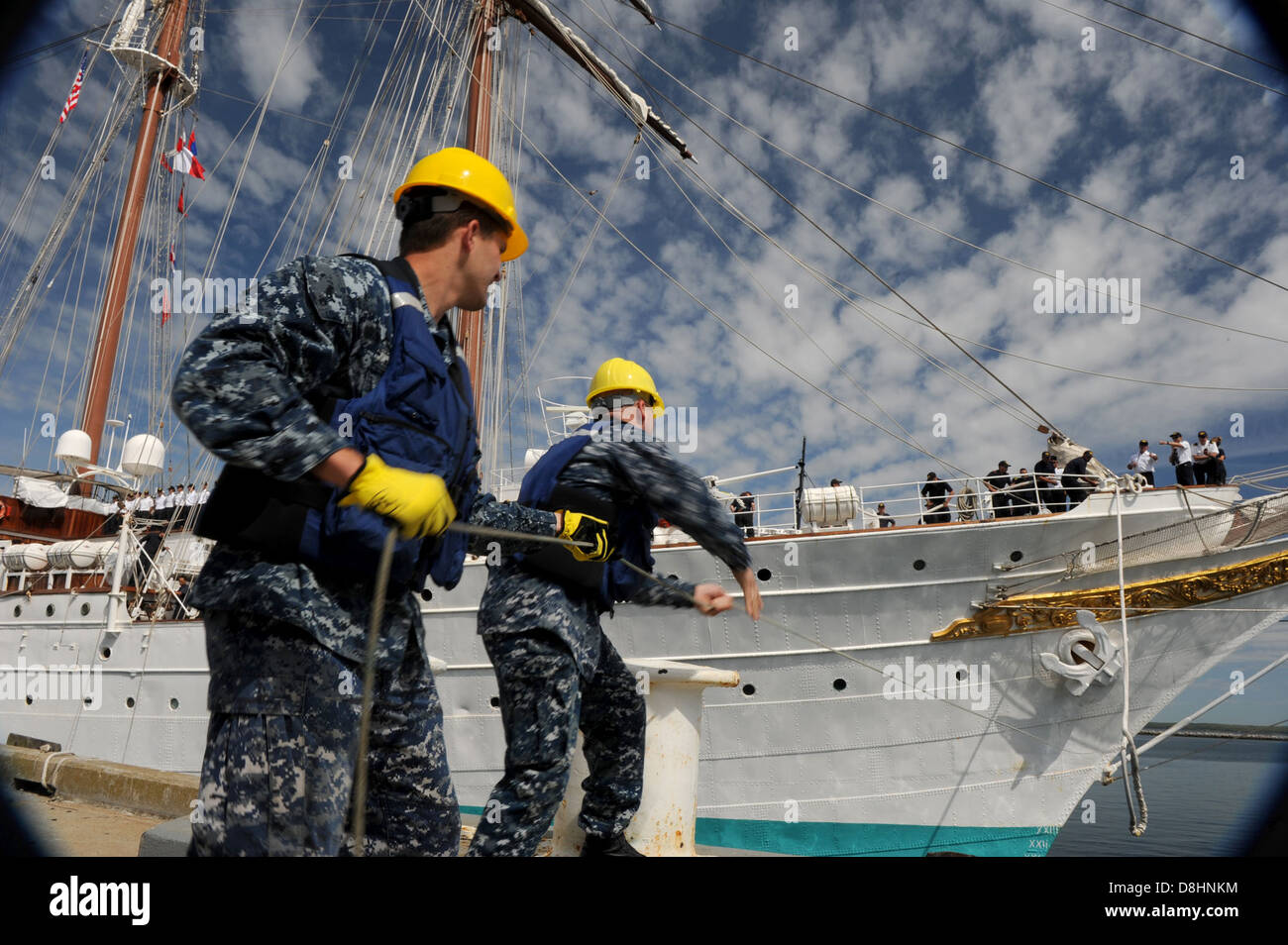 Sailors handle lines for a Spanish navy ship. Stock Photo