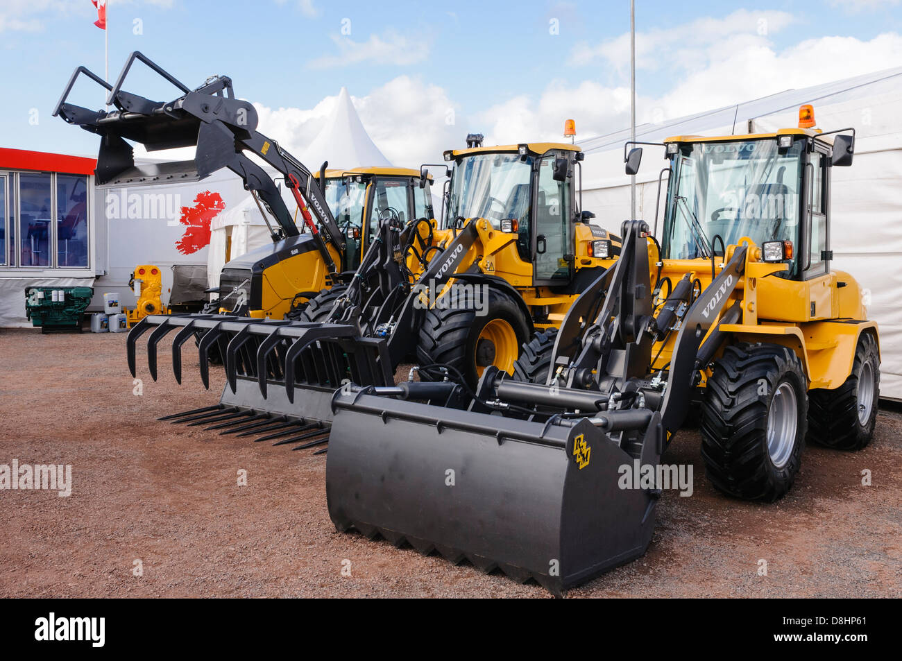 Selection of Volvo farm tractors with various front attachments Stock Photo