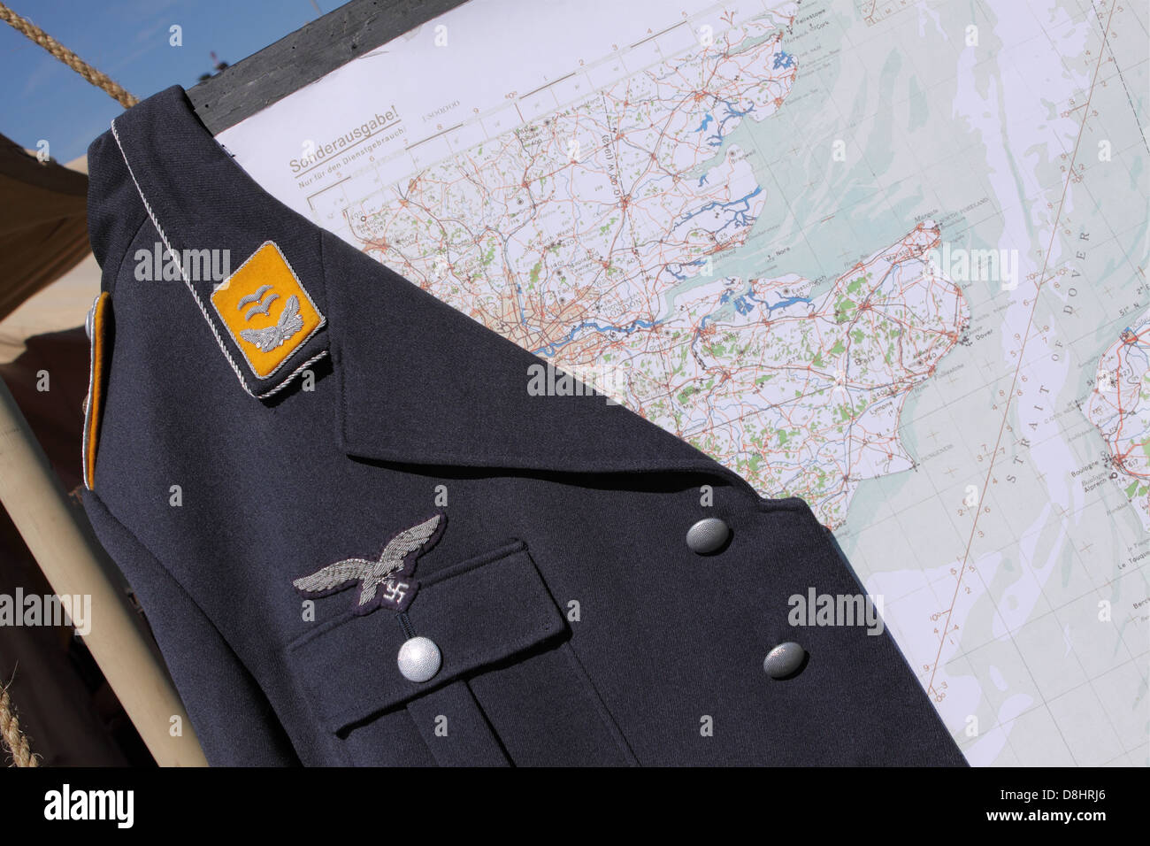 Luftwaffe WW2 jacket hanging over a German map of England and the English Channel Stock Photo