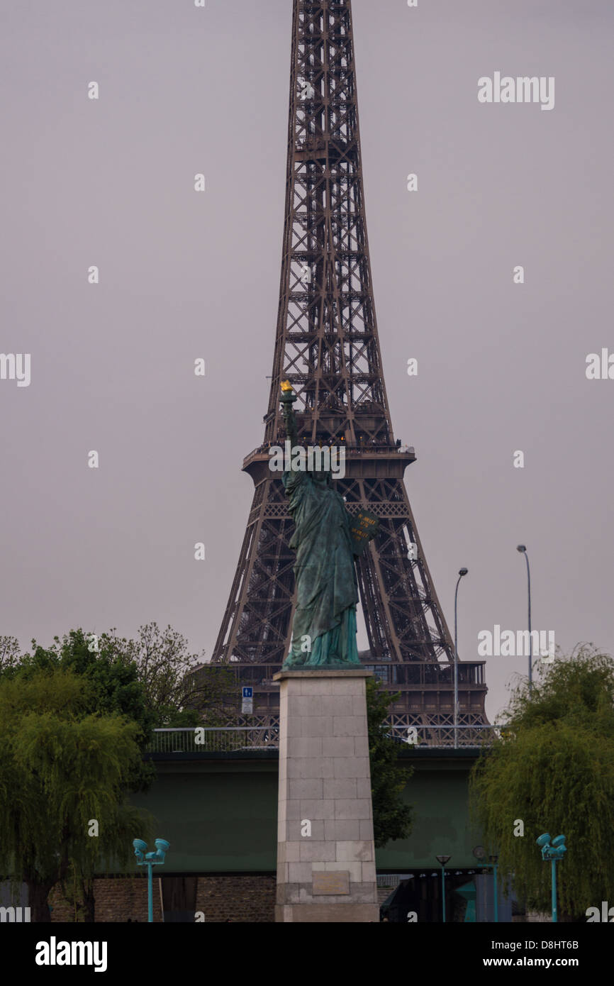 Paris, France. A small Statue of Liberty stands in front of the Eiffel