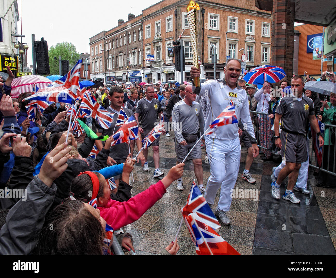 Runner 071 Brings the olympic flame into Warrington up Sankey St, near Golden Square shopping area Stock Photo