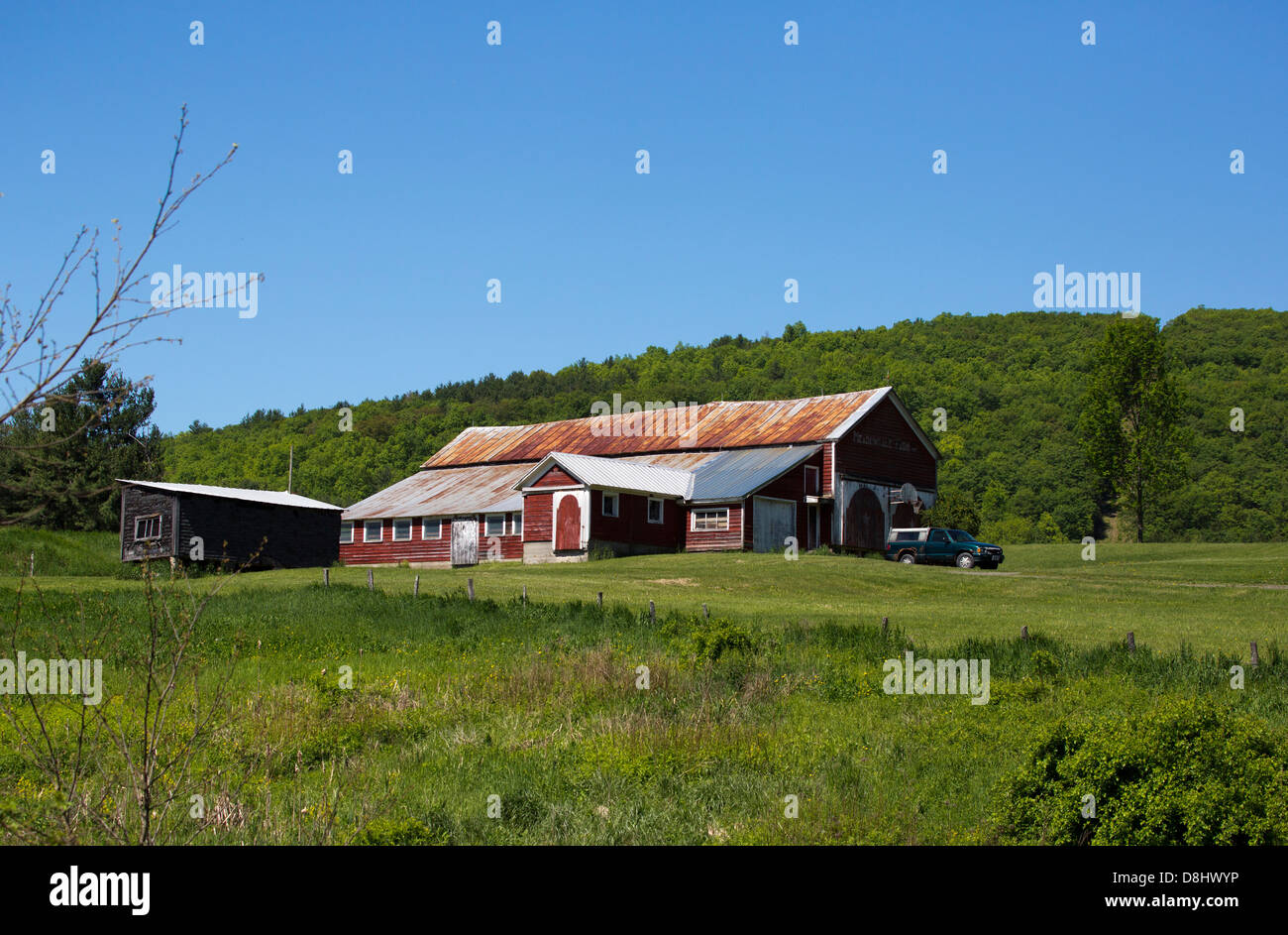 Vintage farm barn with a rusty metal roof. Stock Photo