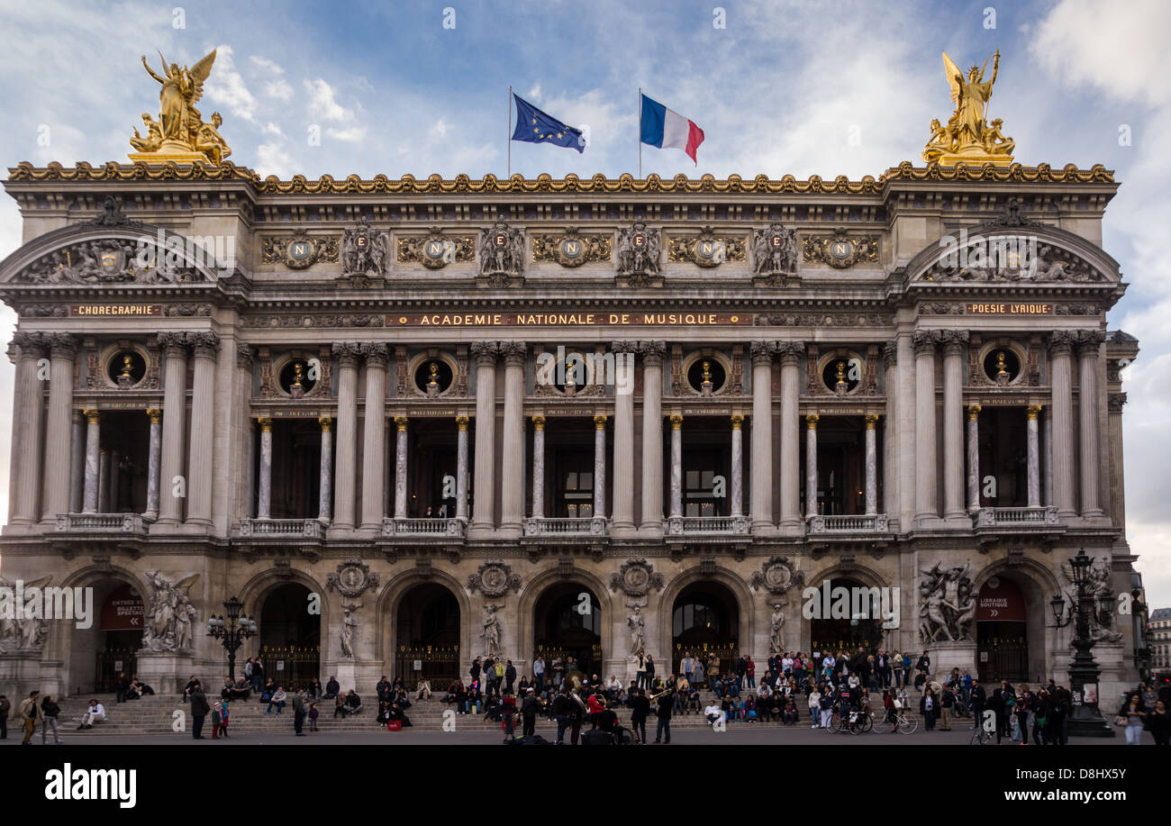 France. People in front of the Paris opera house. French and European Union flags on top. Stock Photo