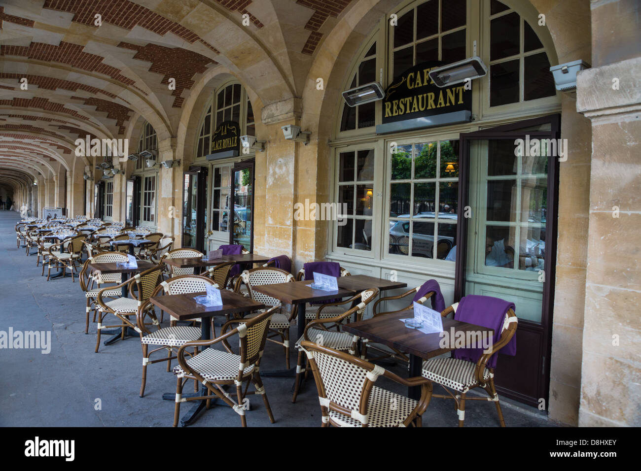 Paris, France. Tables outside a restaurant, in the Place des Voges, Marais quarter. Stock Photo