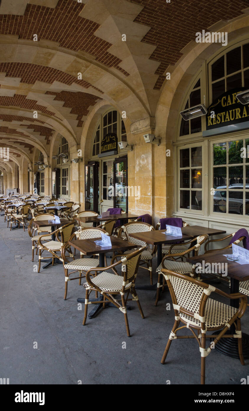 Paris, France. Tables outside a restaurant, in the Place des Voges, Marais quarter. Stock Photo