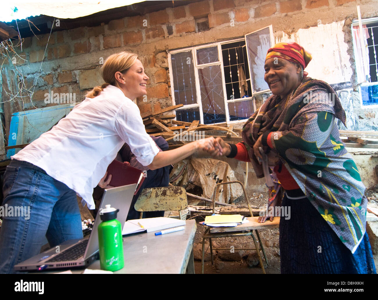 An European Homeopathic Dr. greets a patient in a rural clinic in northern Tanzania. Stock Photo