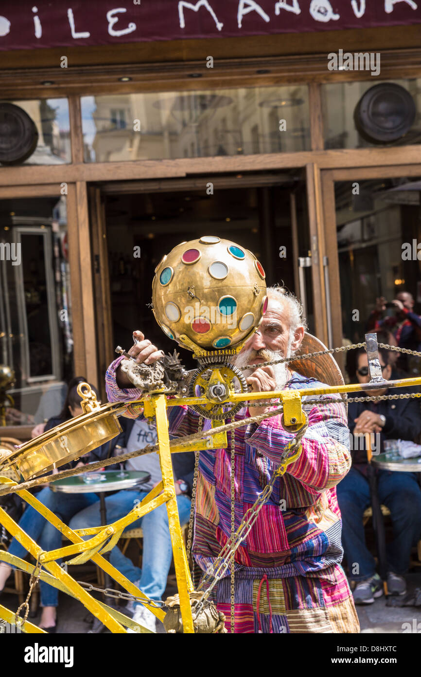 Paris,France. A colorful man works on his rickshaw with devices ...