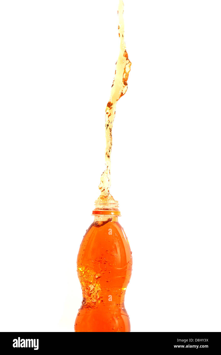 The Orange juice that spread out from the bottle on The white Background. Stock Photo