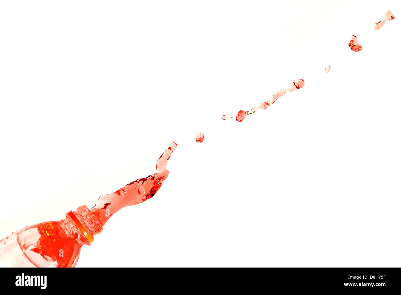 The Red water that spread out from the bottle on The white Background. Stock Photo