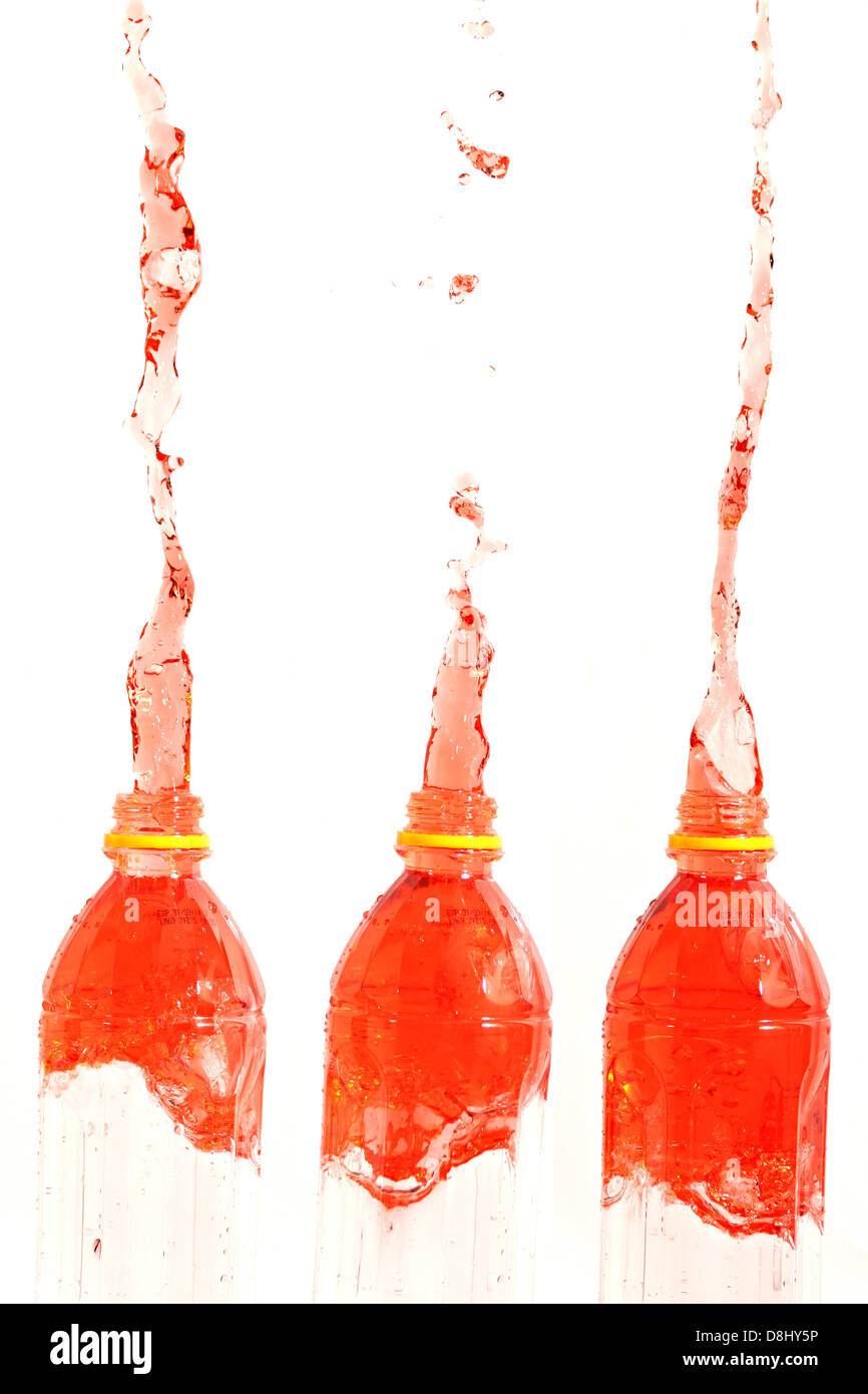 The Red water that spread out from the Three bottle on The white Background. Stock Photo