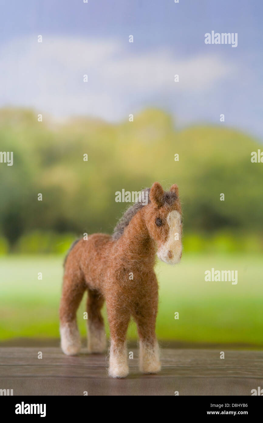 Felt Toy Horse on Printed Background Paper Stock Photo