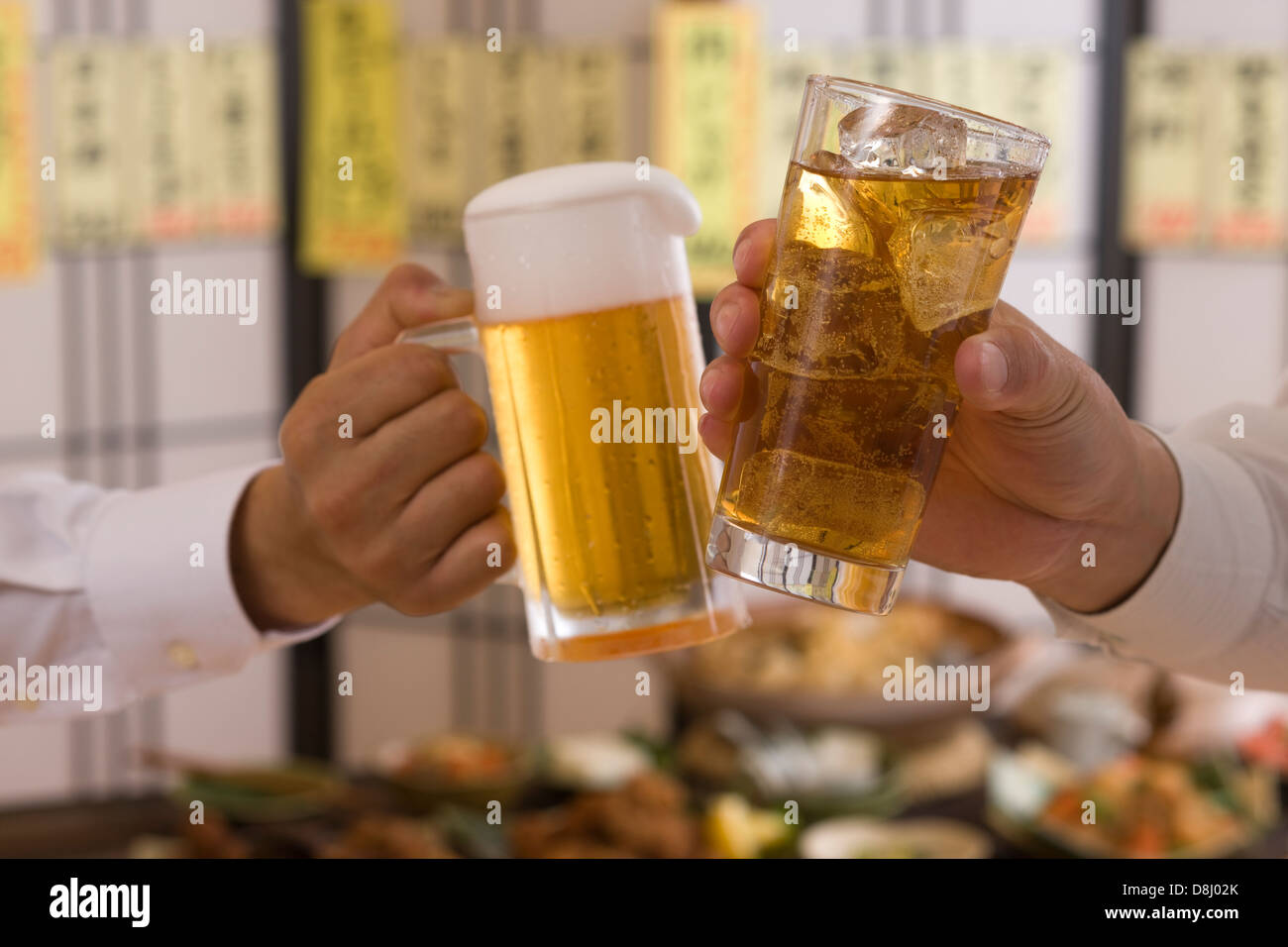 Two People Toasting with Beer and Chu-Hi at Izakaya Stock Photo