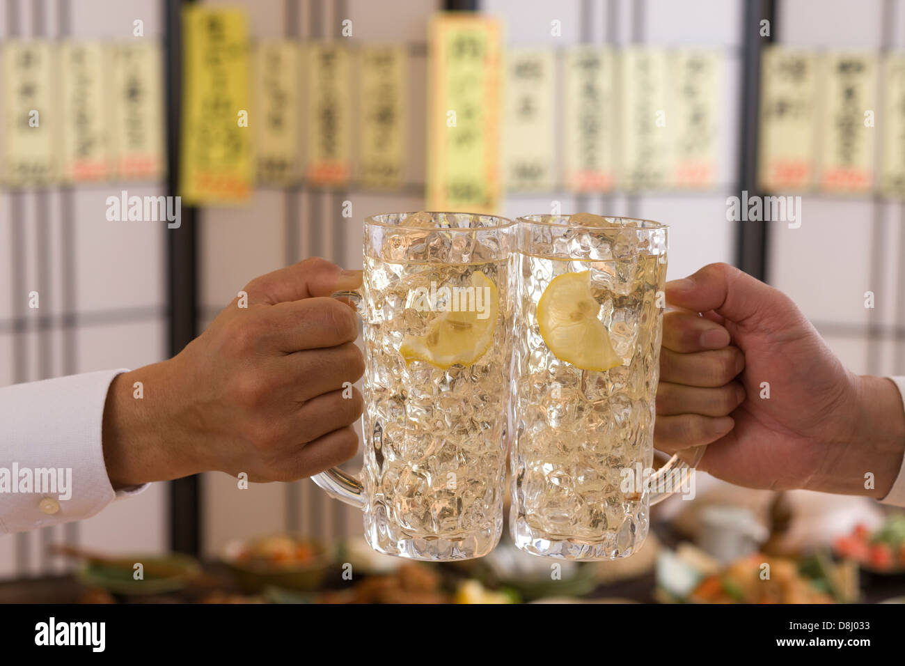 Two People Toasting with Whisky and Soda at Izakaya Stock Photo