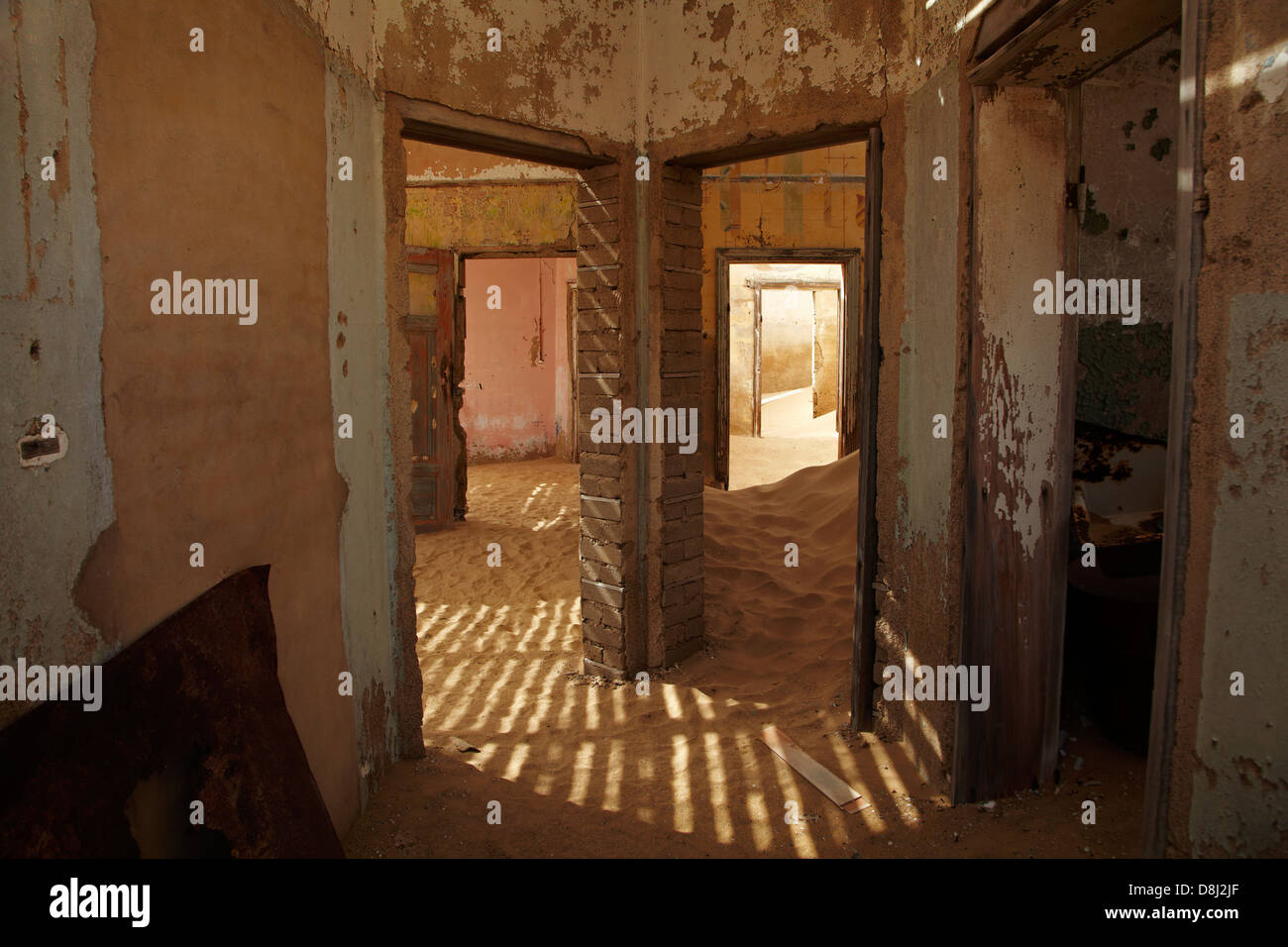 Sand and doorways inside abandoned house, Kolmanskop Ghost Town, near Luderitz, Namibia, Africa Stock Photo