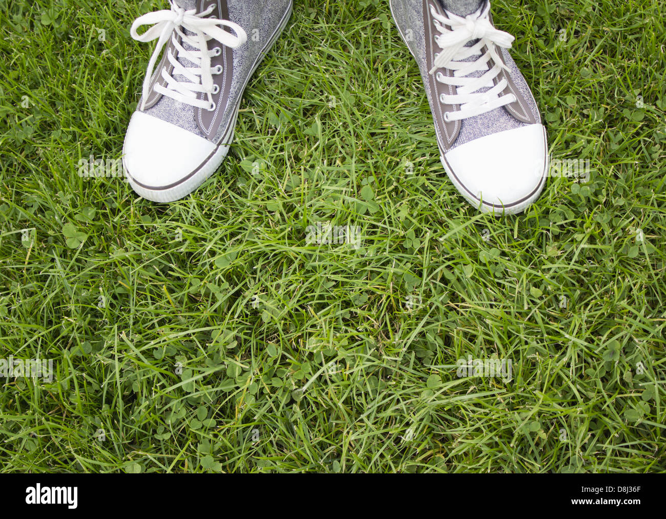 Person wearing rain boots and lawn Stock Photo