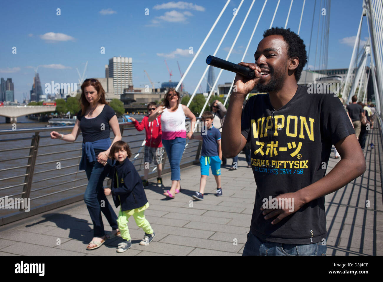 Rapper / busker on Golden Jubilee Bridge perform music to passers by ...