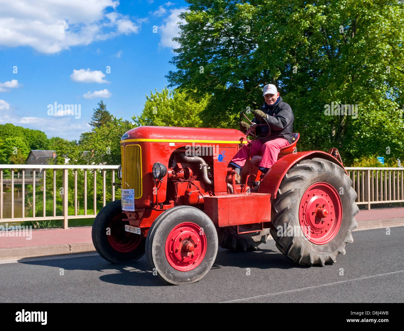 French farmer driving old restored unnamed tractor on "Retro