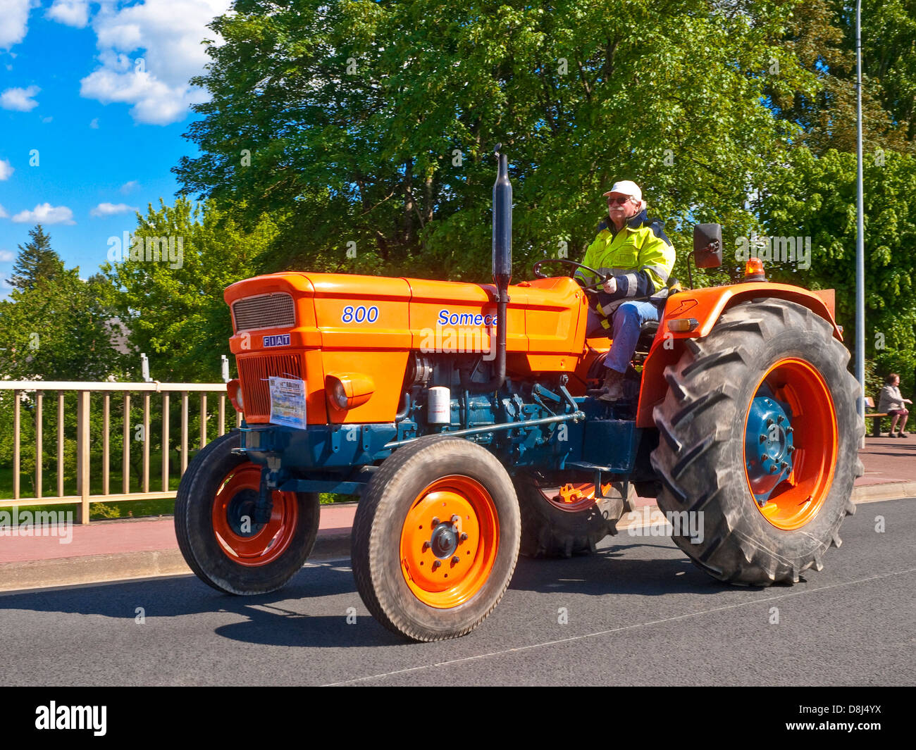 French farmer driving old restored 1968 Fiat Someca tractor on 'Retro-Méchanique' rally - France. Stock Photo