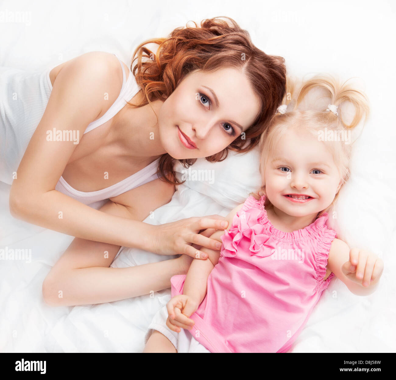 happy young mother and baby in bed at home Stock Photo Alamy
