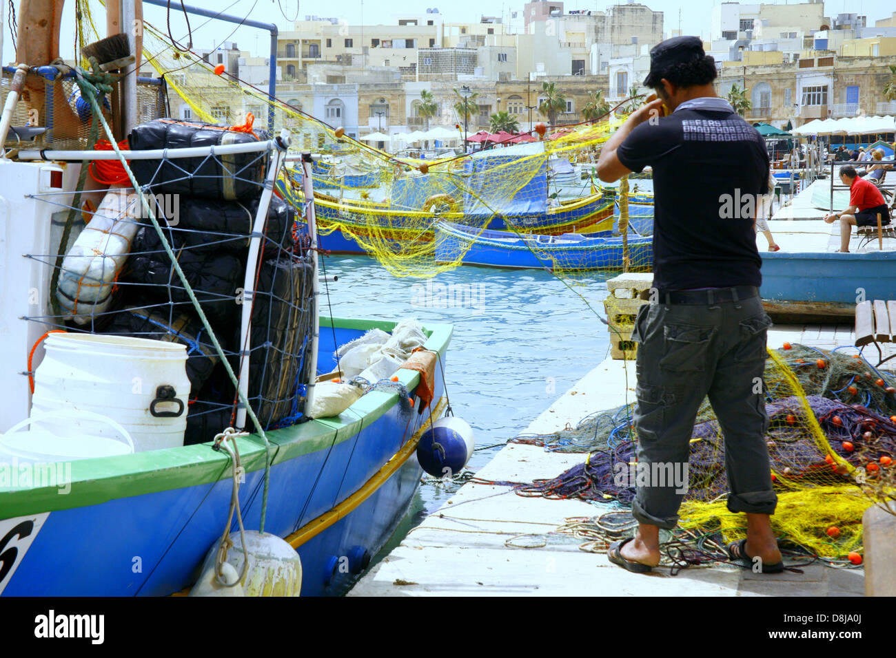 A Fisherman Checking His Nets On The Quayside At Marsaxlokk Malta Stock Photo Alamy A Fisherman Checking His Nets On The Quayside At Marsaxlokk Malta Stock Photo Alamy