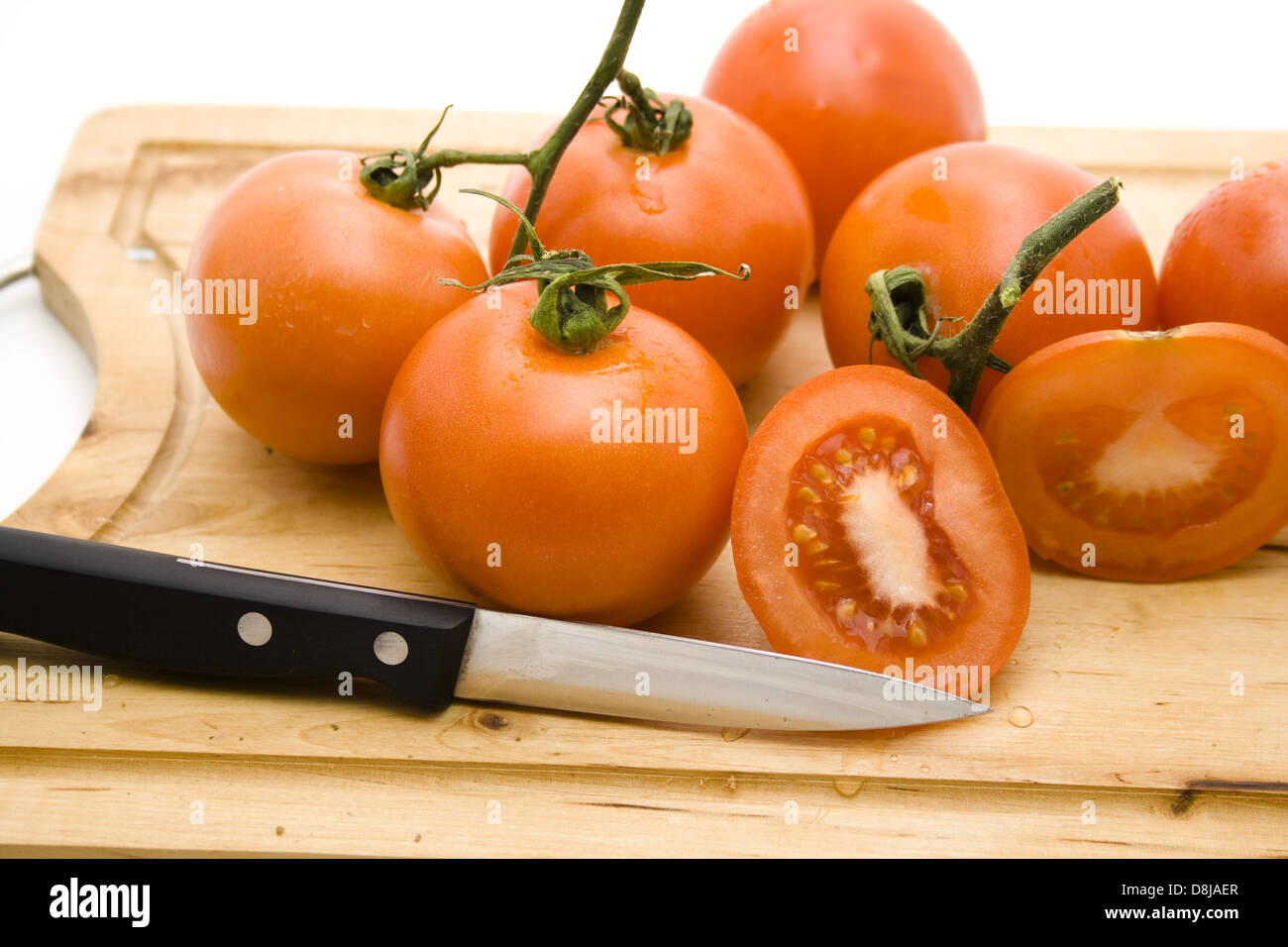 Tomatoes with knife Stock Photo - Alamy