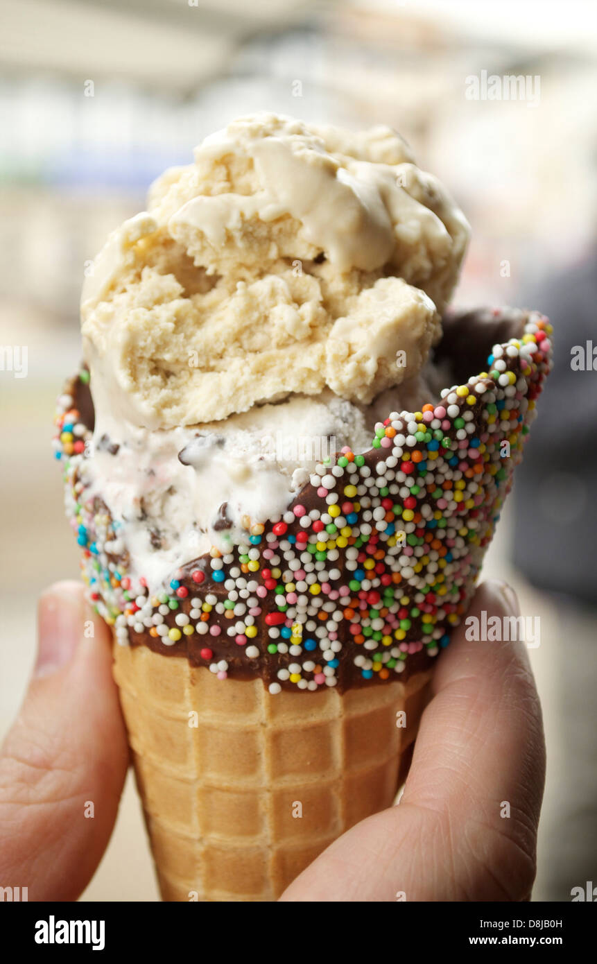 Hand holding an Ice Cream with cone Stock Photo