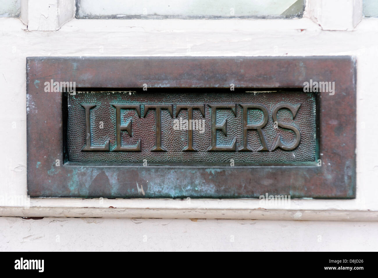 Mail door slot with embossed label Letters Stock Photo - Alamy