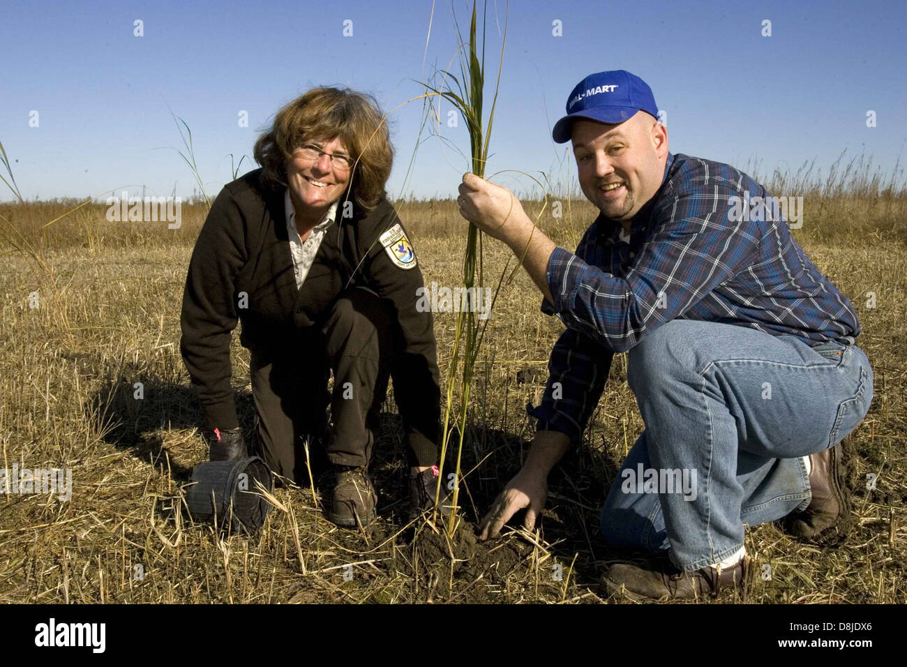 A man and woman are shown planting a tree together, working to restore ...