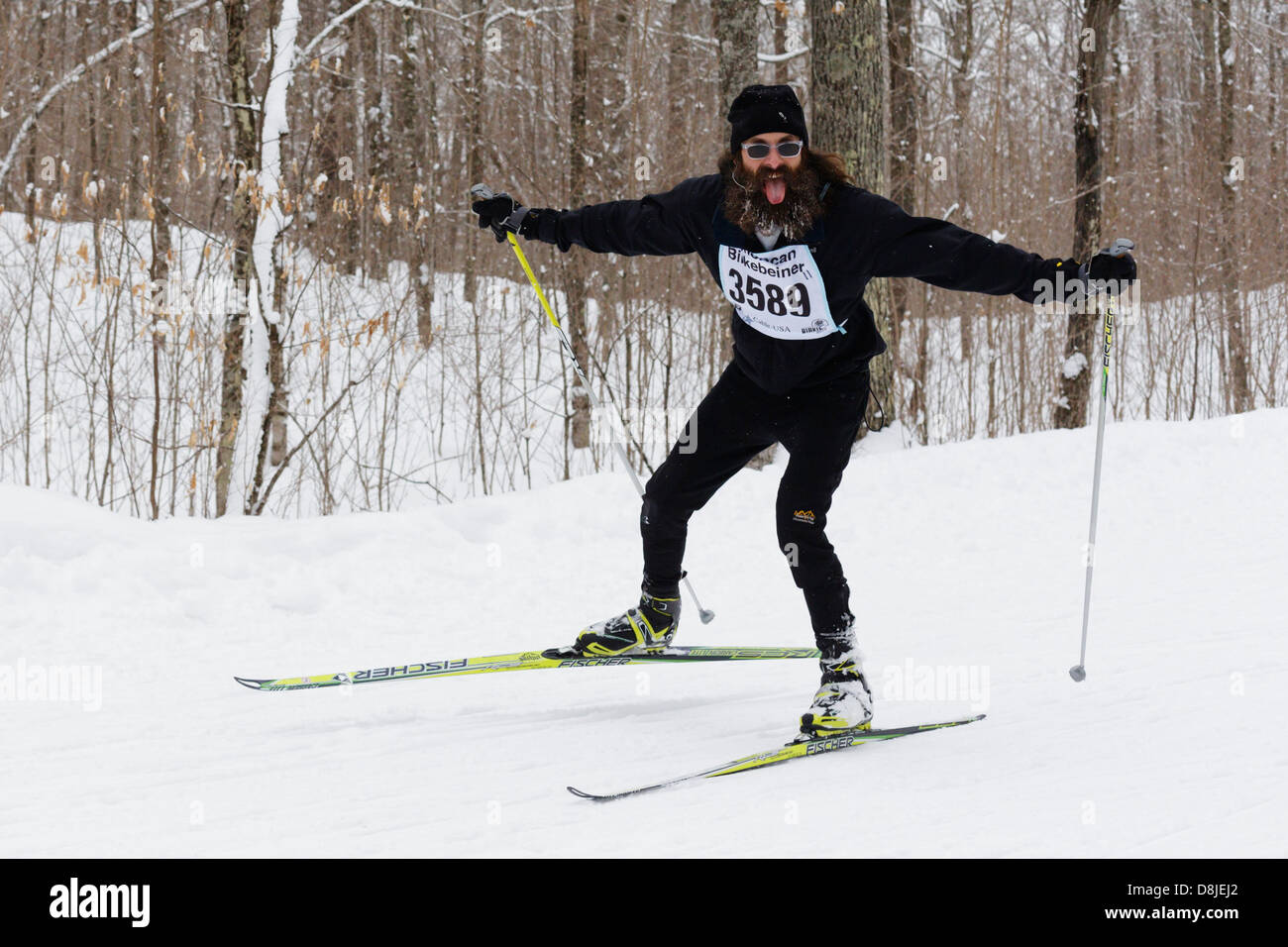 A man reacts to a photographer while skiing in the American Birkebeiner on the trail between Cable and Hayward, Wisconsin. Stock Photo