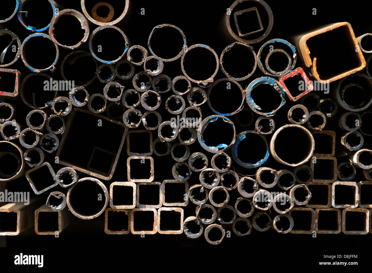 Stacked steel pipes and tubes background Stock Photo