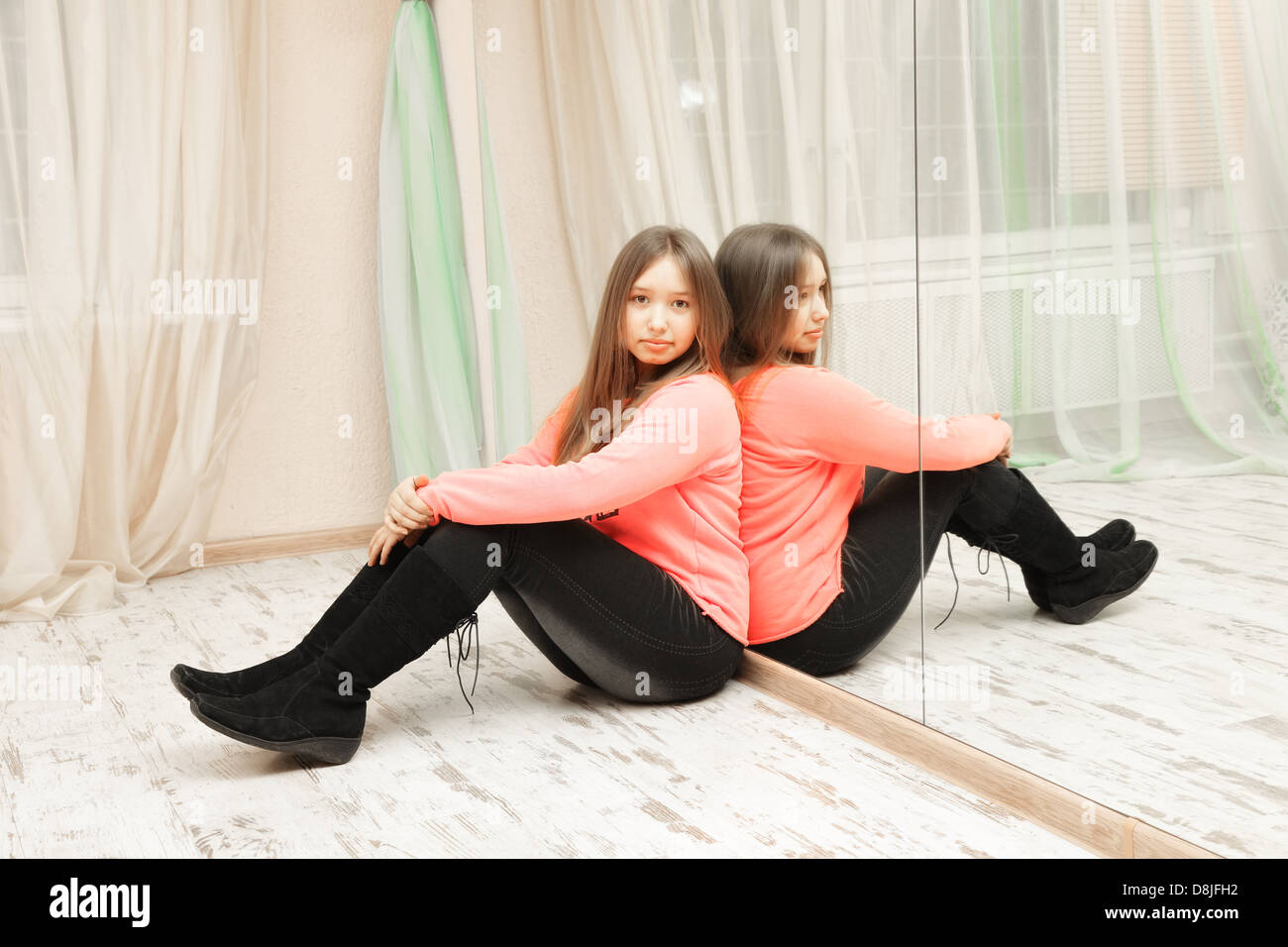 Teenage girl sitting on the floor Stock Photo - Alamy