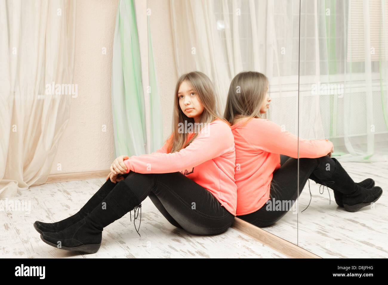 Sad teenage girl sitting on the floor Stock Photo - Alamy