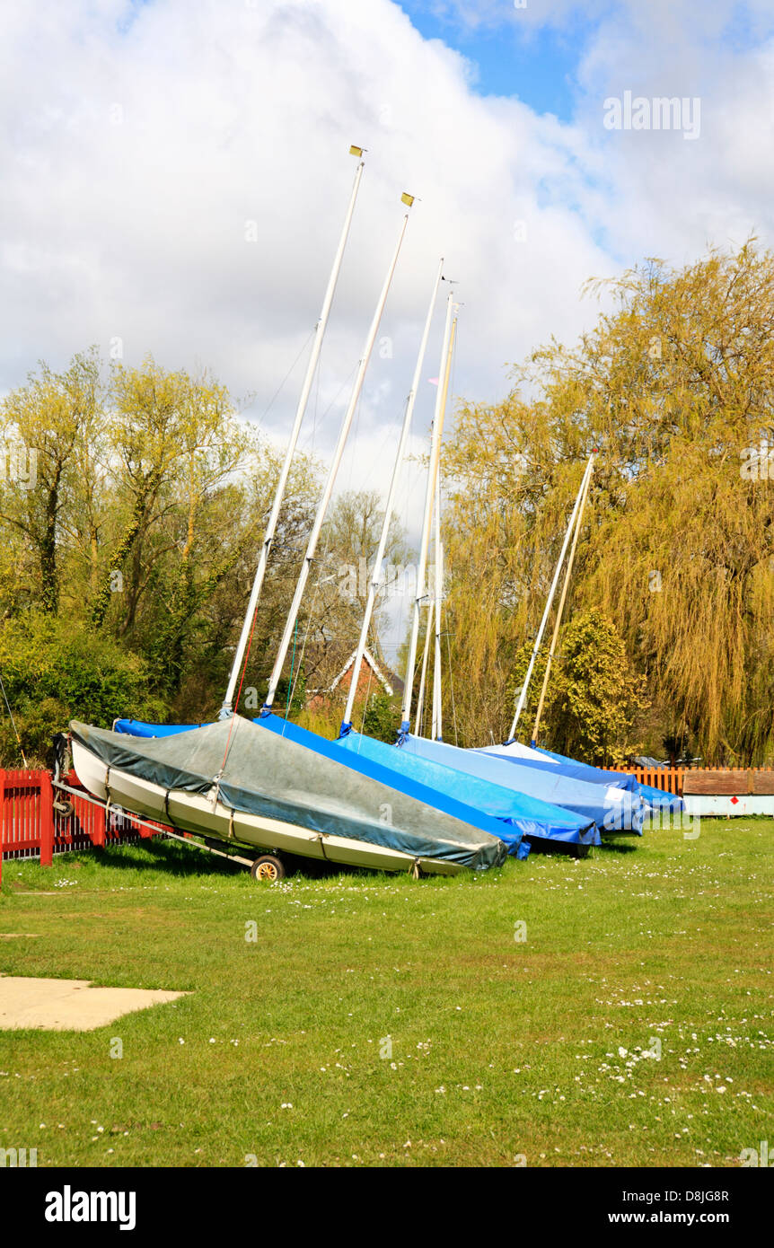 A line of sailing dinghies out of water at Coldham Hall, Norfolk