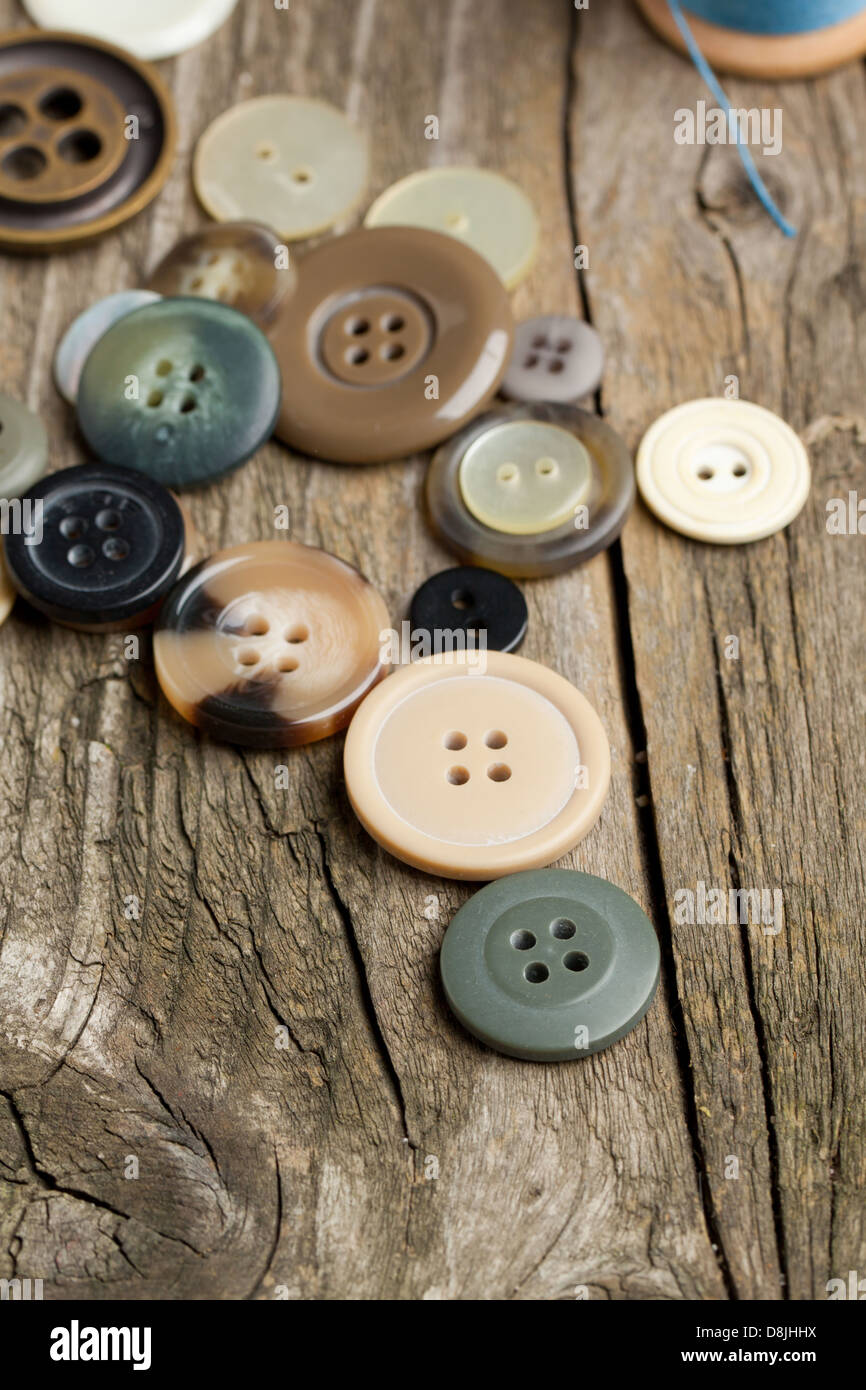 Collection of various buttons on old wooden table Stock Photo - Alamy