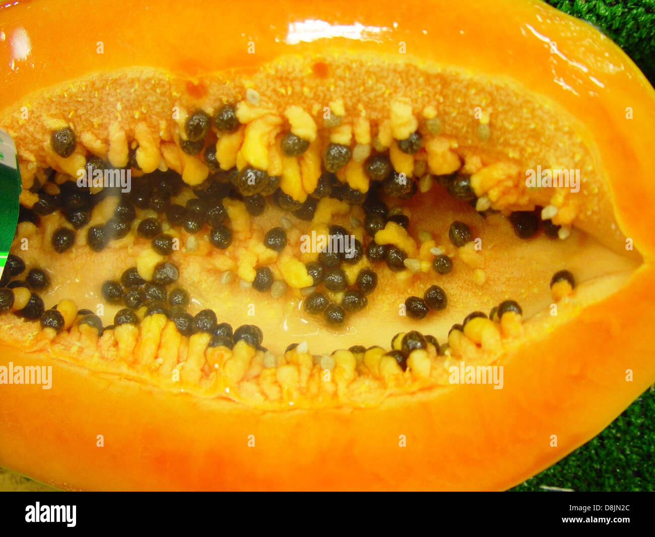 Talap An image of a pawpaw fruit sliced open, showing its creamy yellow flesh ...