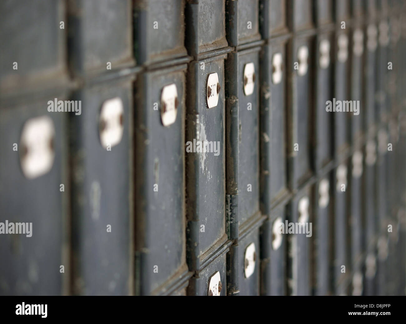 Many rows of old fashioned mailboxes that are weathered and worn Stock Photo