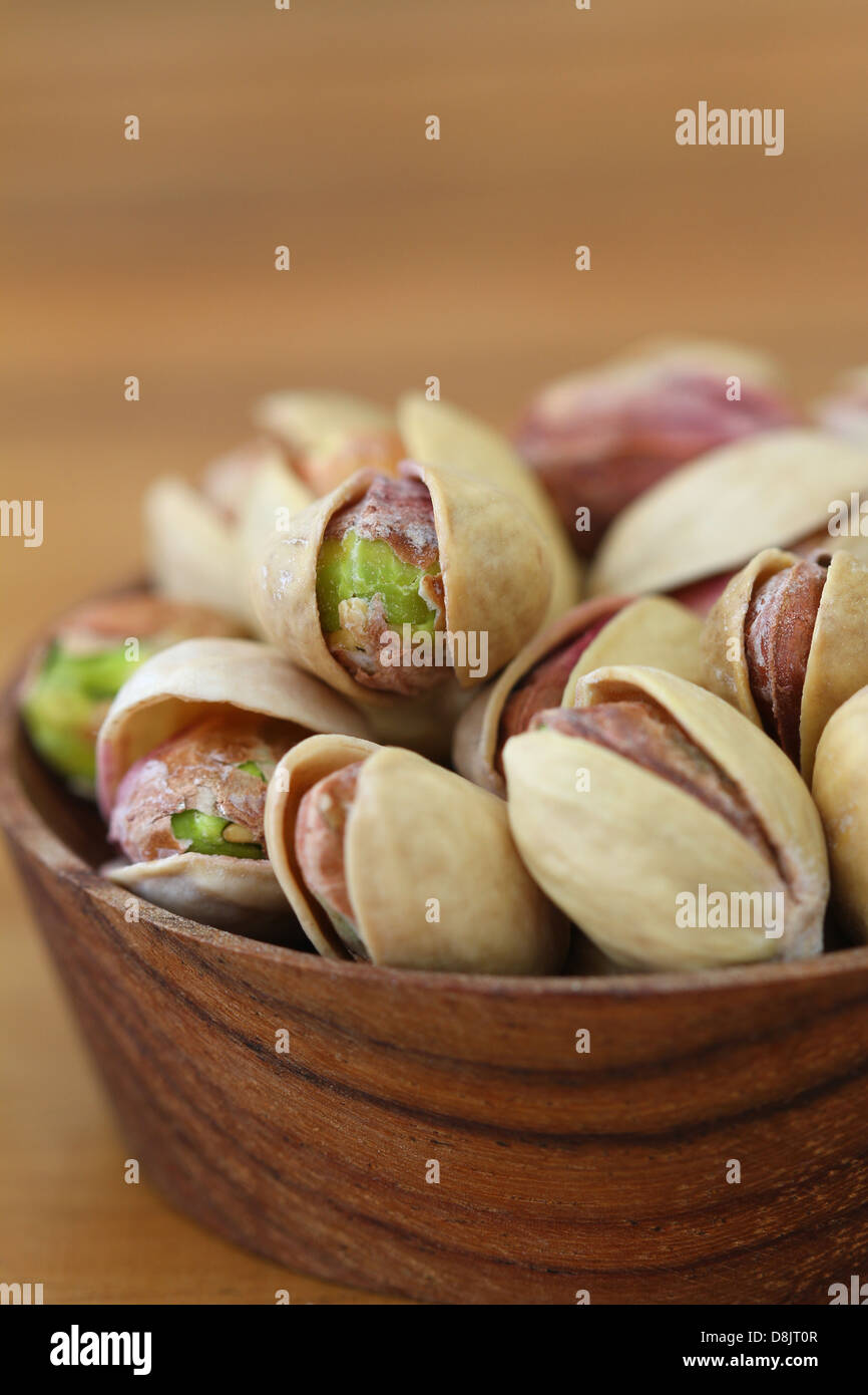 Pistachios in wooden bowl, close up Stock Photo Alamy