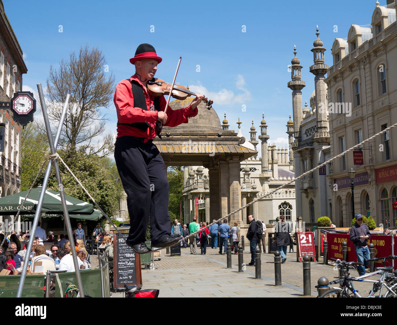 Street entertainment  - man on tightrope near Brighton Royal Pavilion at Brighton Festival, 2013 Stock Photo