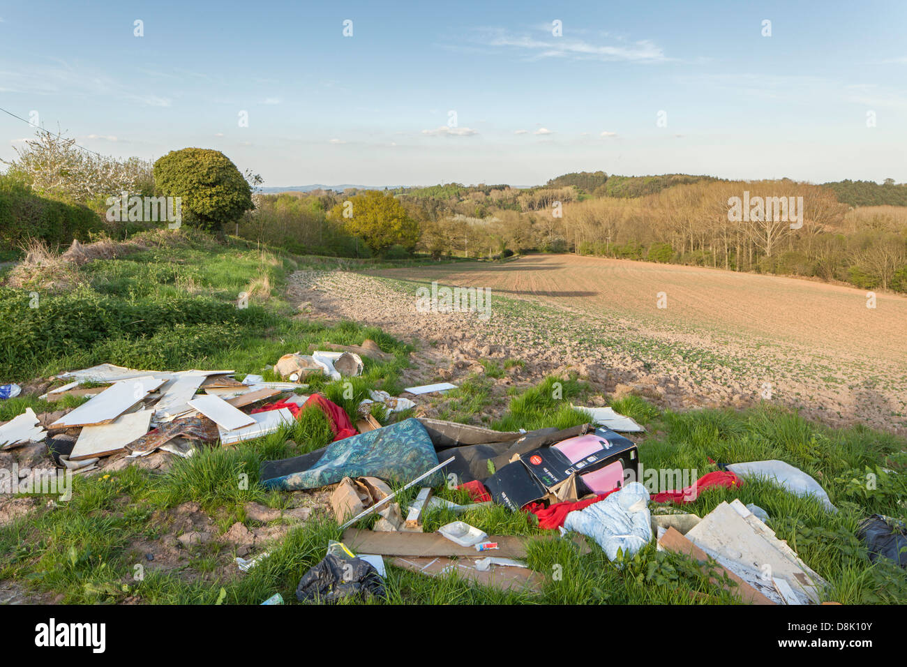 Illegal fly tipping on farmland in the English countryside, Worcestershire, England, UK Stock Photo