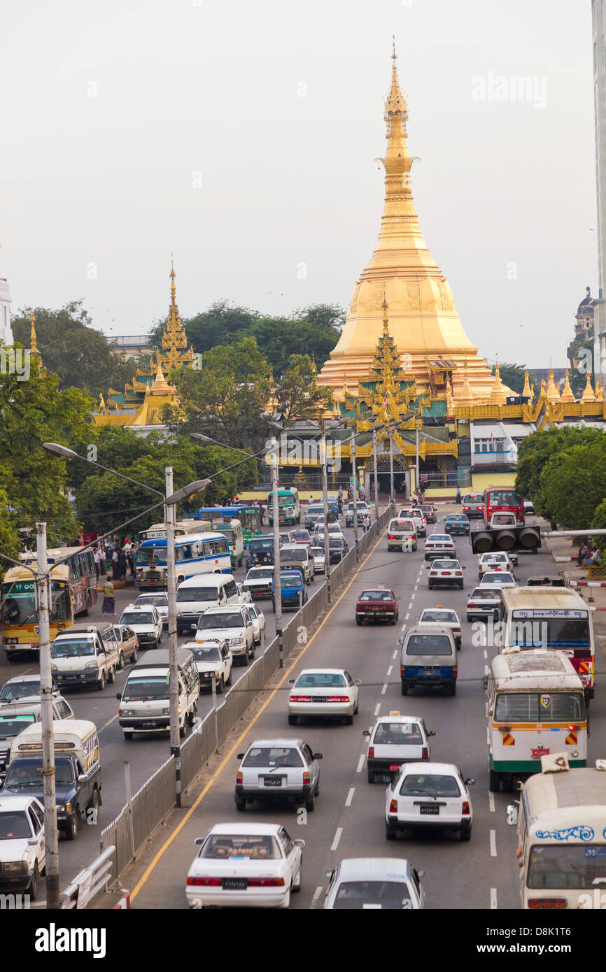 Golden Sule pagoda in the middle of a roundabout in heavy city traffic in Burma, Yangon, Stock Photo
