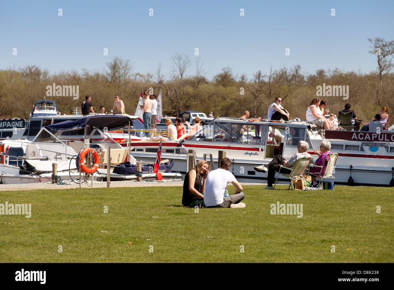 People enjoying the sunshine on May Bank Holiday weekend, Maltster Broad, Norfolk Broads UK Stock Photo