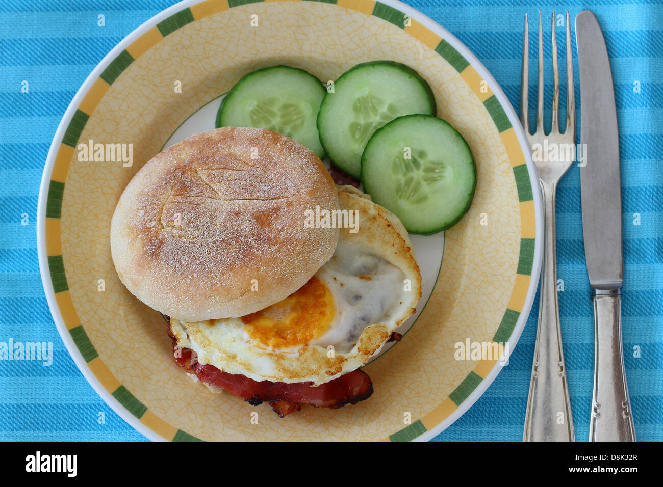 English muffin with fried egg and bacon Stock Photo