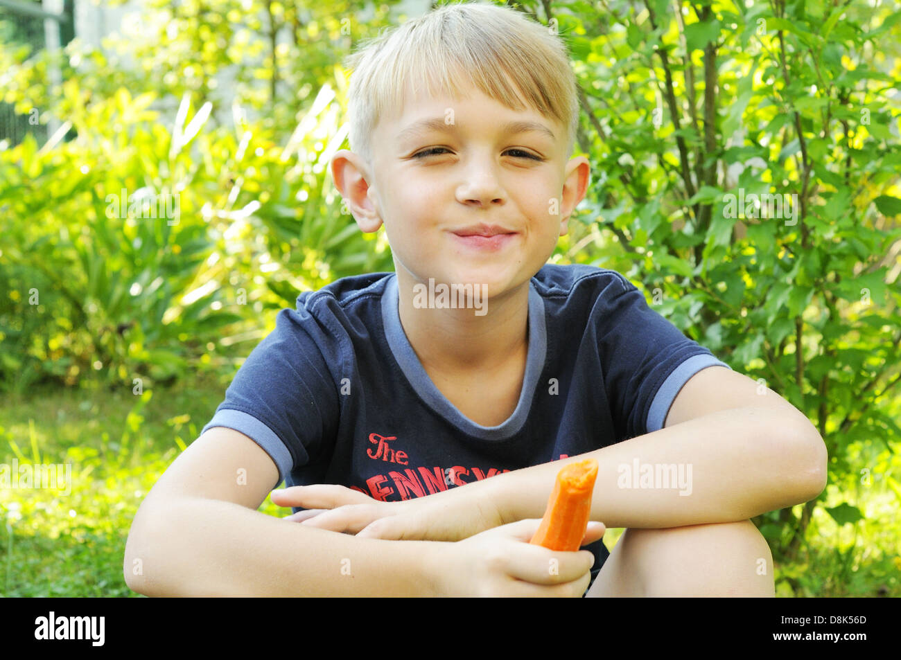 Boy with carrot Stock Photo