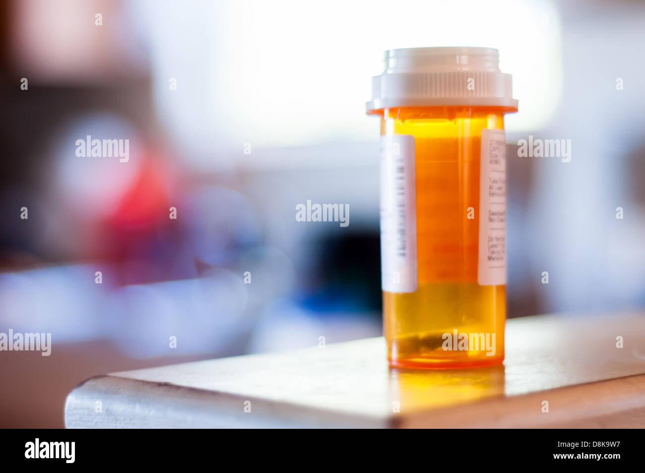 Running out of medicine as seen in a nearly empty pill bottle. Stock Photo