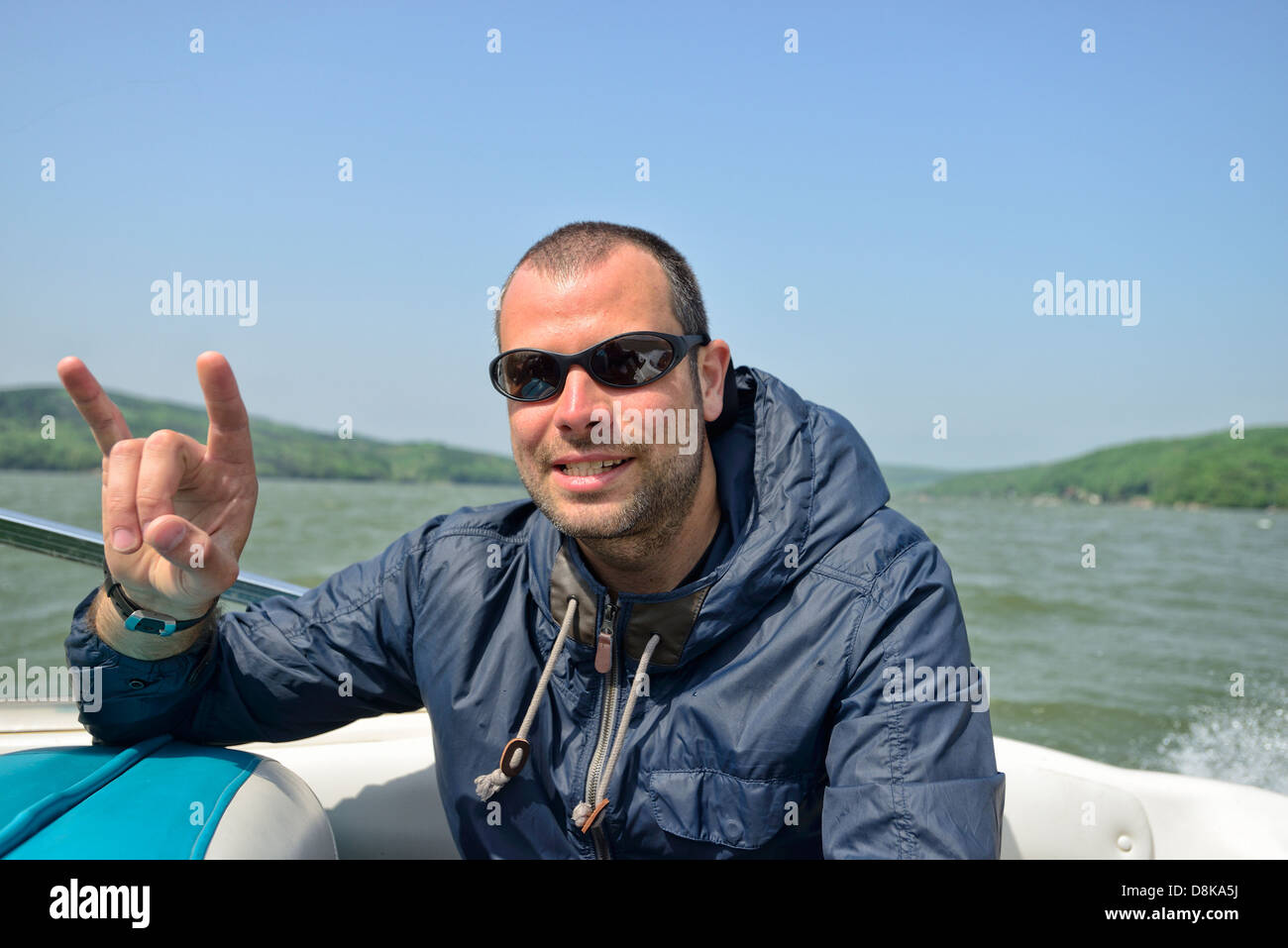 Man in a motorboat speeding away, smiling away and gesturing Stock ...