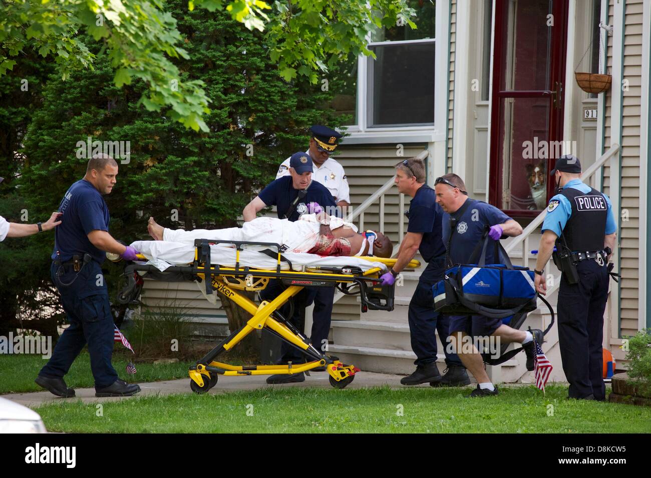 Oak Park, Illinois, USA, 30th May 2013. Oak Park Fire Department paramedics rush a shooting victim toward a waiting ambulance on the 900 block of north Taylor Avenue. Details and the identity of the victim or shooter are not known at this time. The assailant is still at large. Credit:  Todd Bannor/Alamy Live News Stock Photo