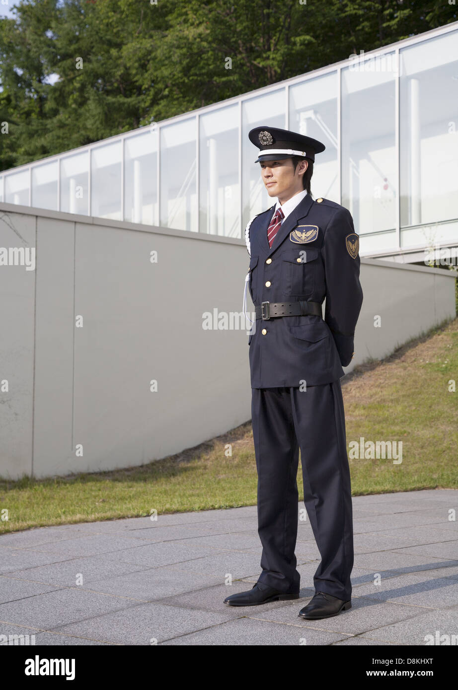 Guard standing behind fence hi-res stock photography and images - Alamy