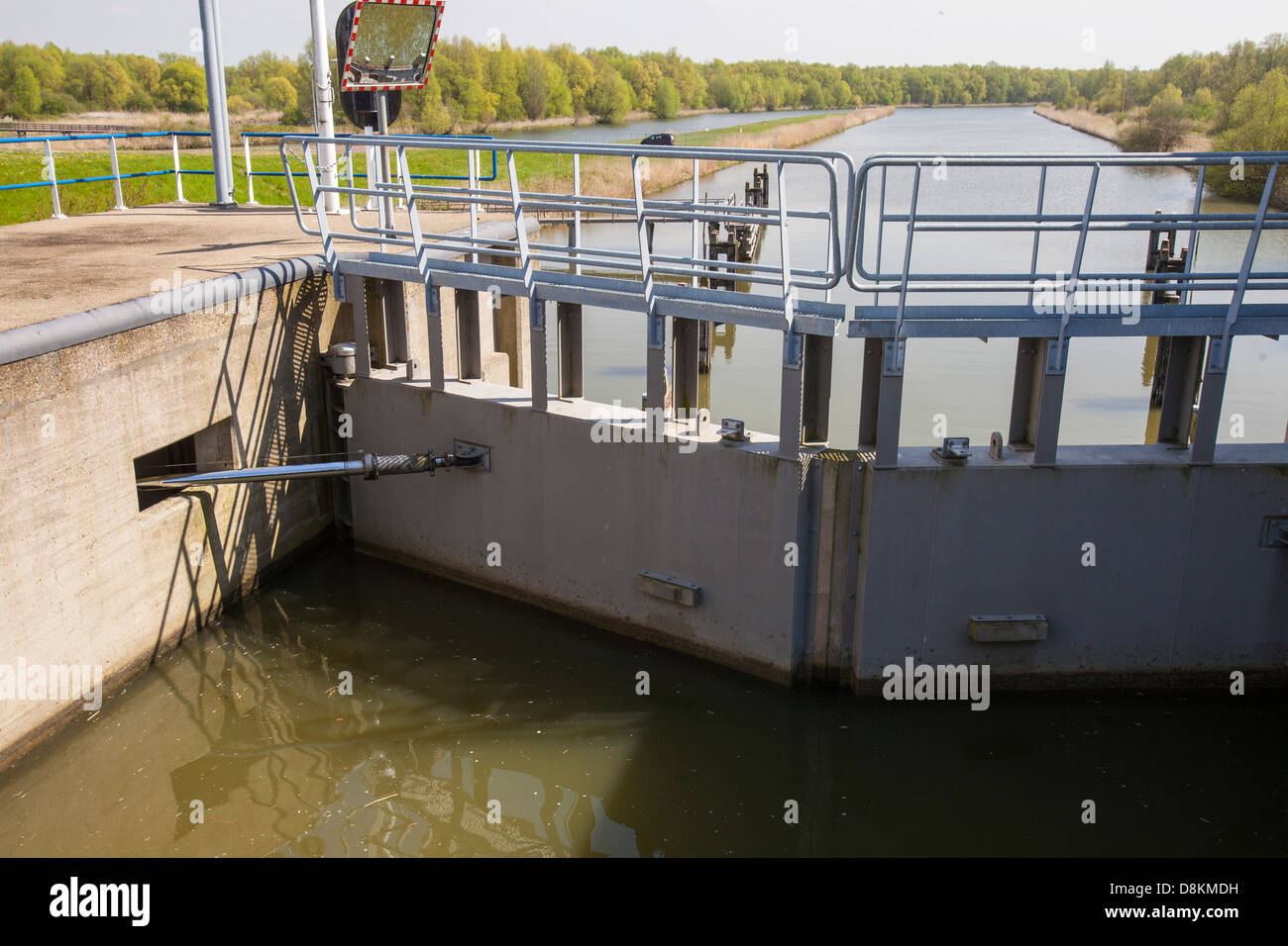 A canal going from the sea to the reclaimed polder land in Holland, north of Amsterdam, which is some 20 feet lower than the sea. With 50% of the Netherlands below sea level, it is incredibly vulnerable to climate change driven sea level rise. Stock Photo